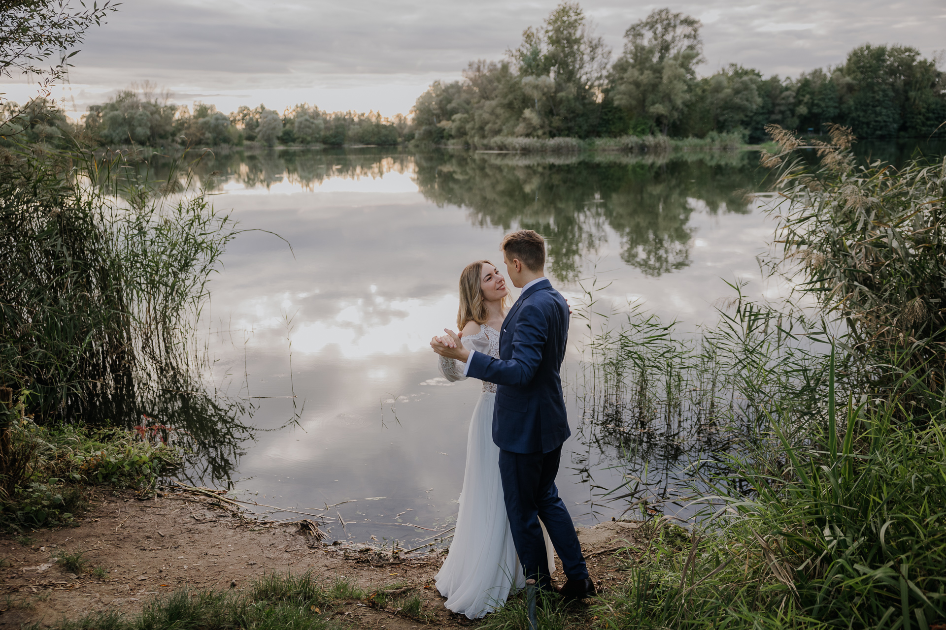 Para Młoda tańczy na tle jeziora w Przylasku Rusieckim