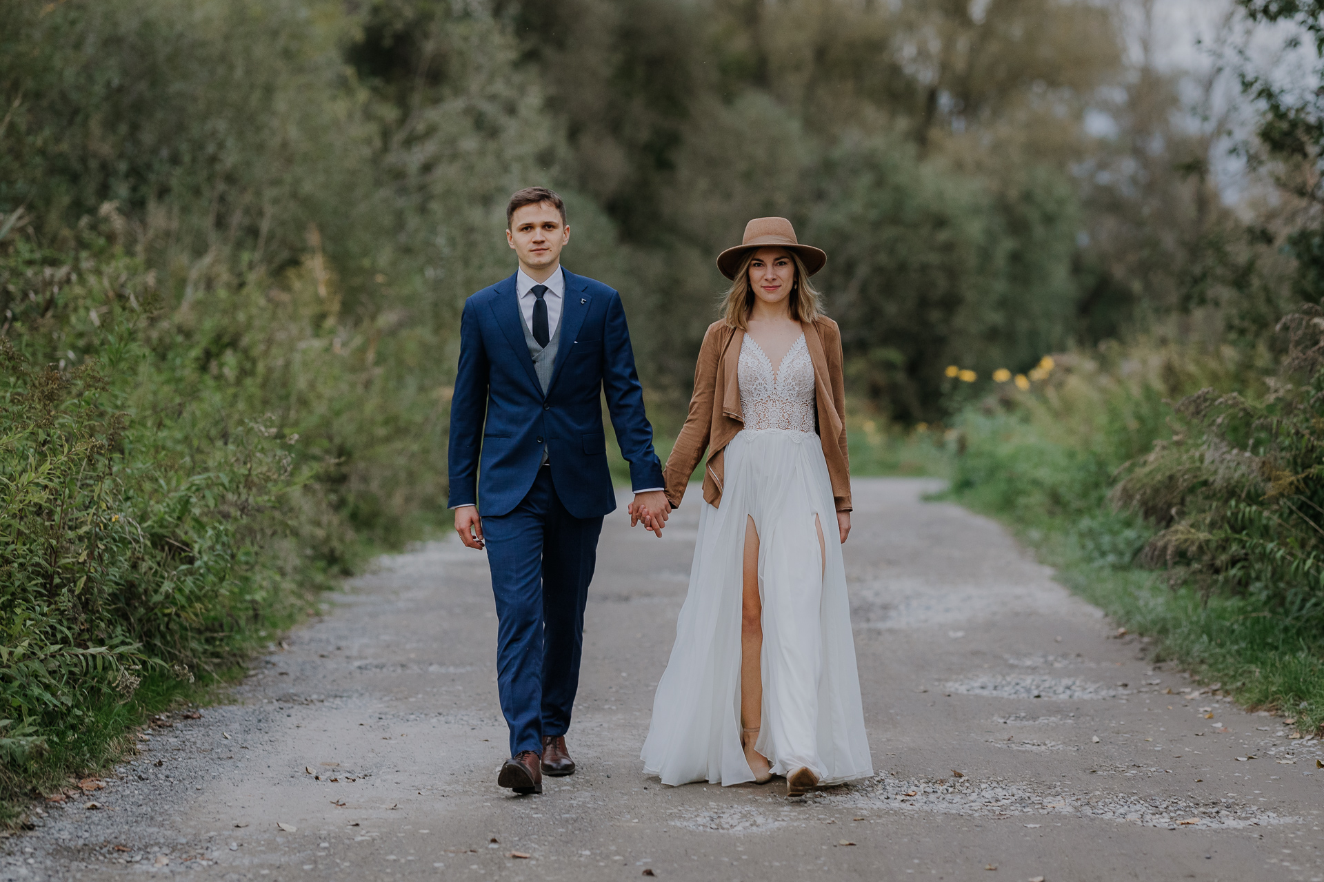 Państwo młodzi idą w Przylasku Rusieckim