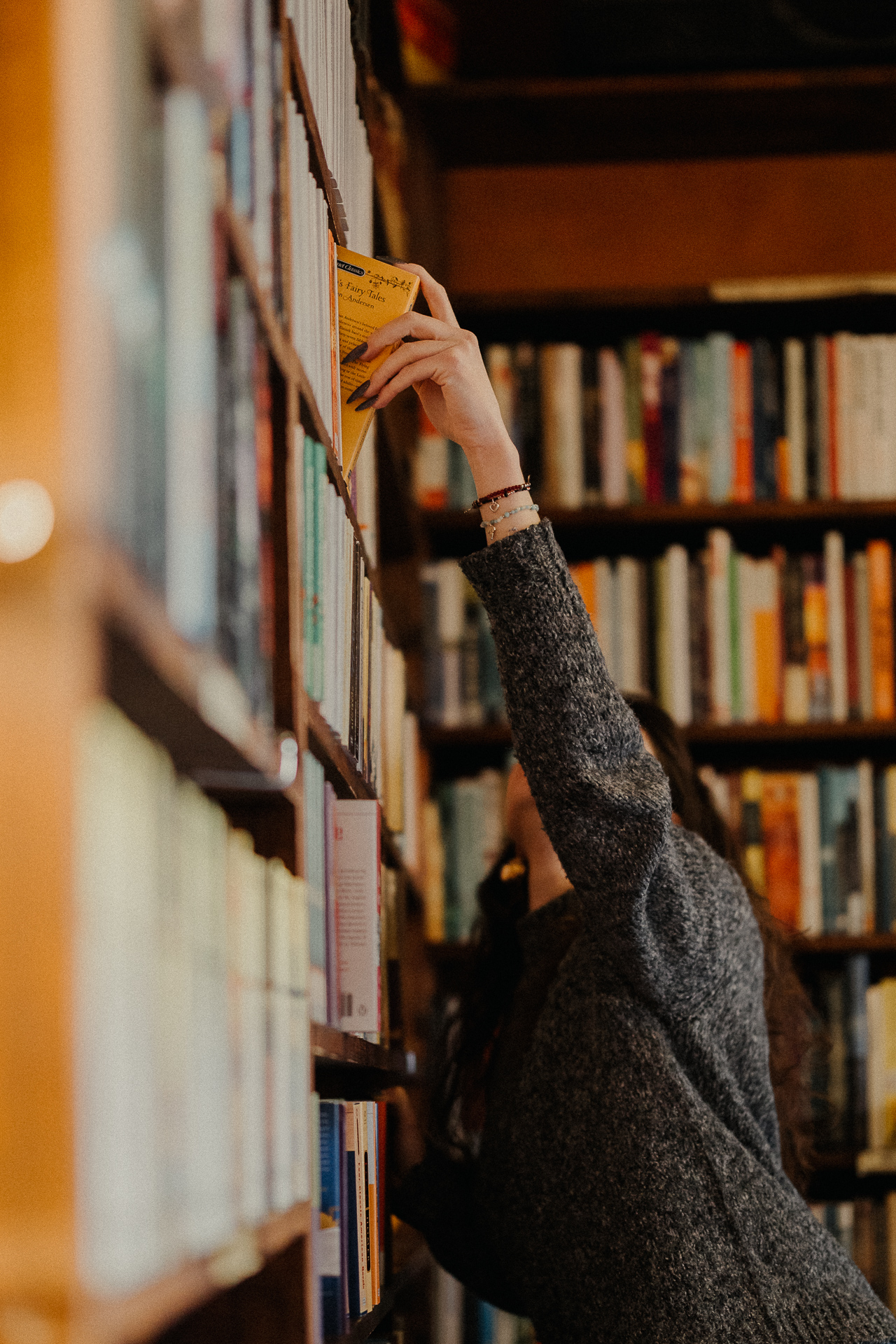 kobieta przy regale z książkami w Massolit w Krakowie