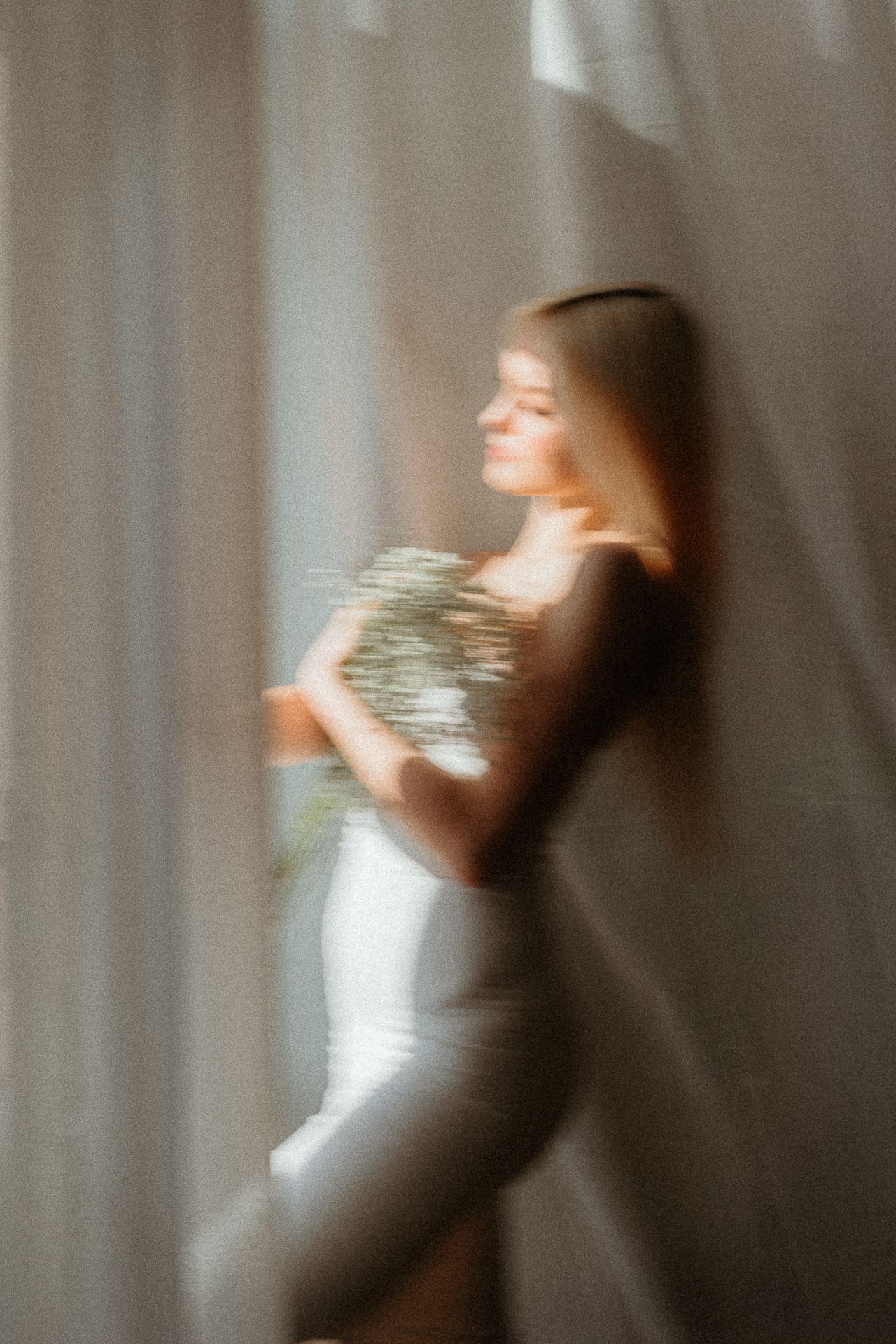 Kreatywne ujęcie kobiety stojącej przy oknie z bukietem gipsówki, portret rozmazany, Atelier Basztowa