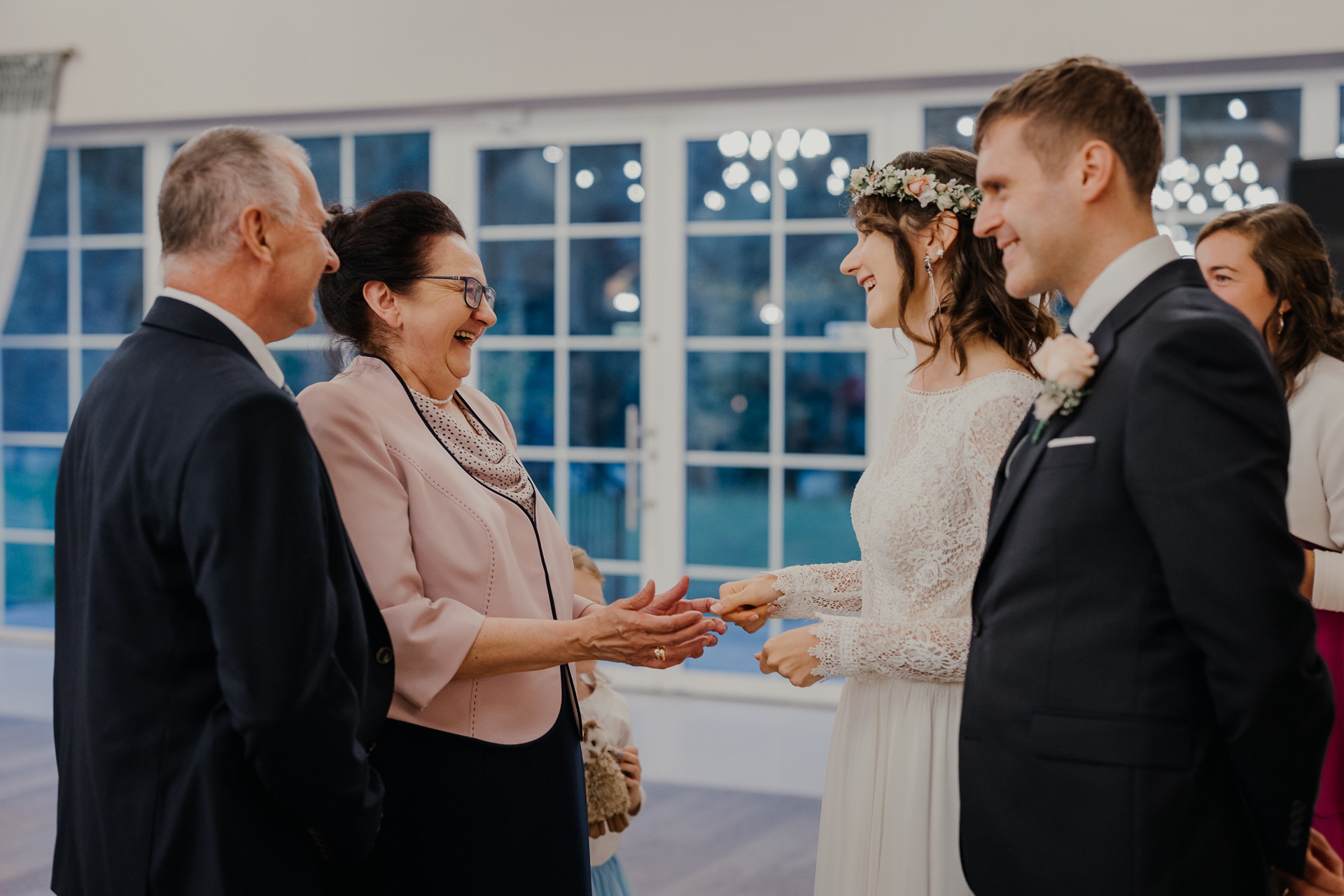 wzruszeni państwo młodzi podczas składania życzeń przez Rodzinę